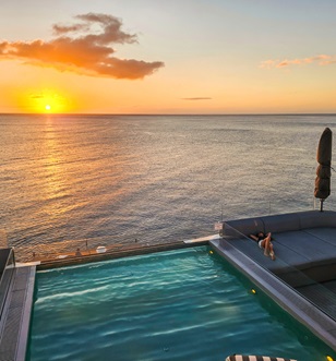 Emerald Sakara pool overlooking the sunset in the Caribbean