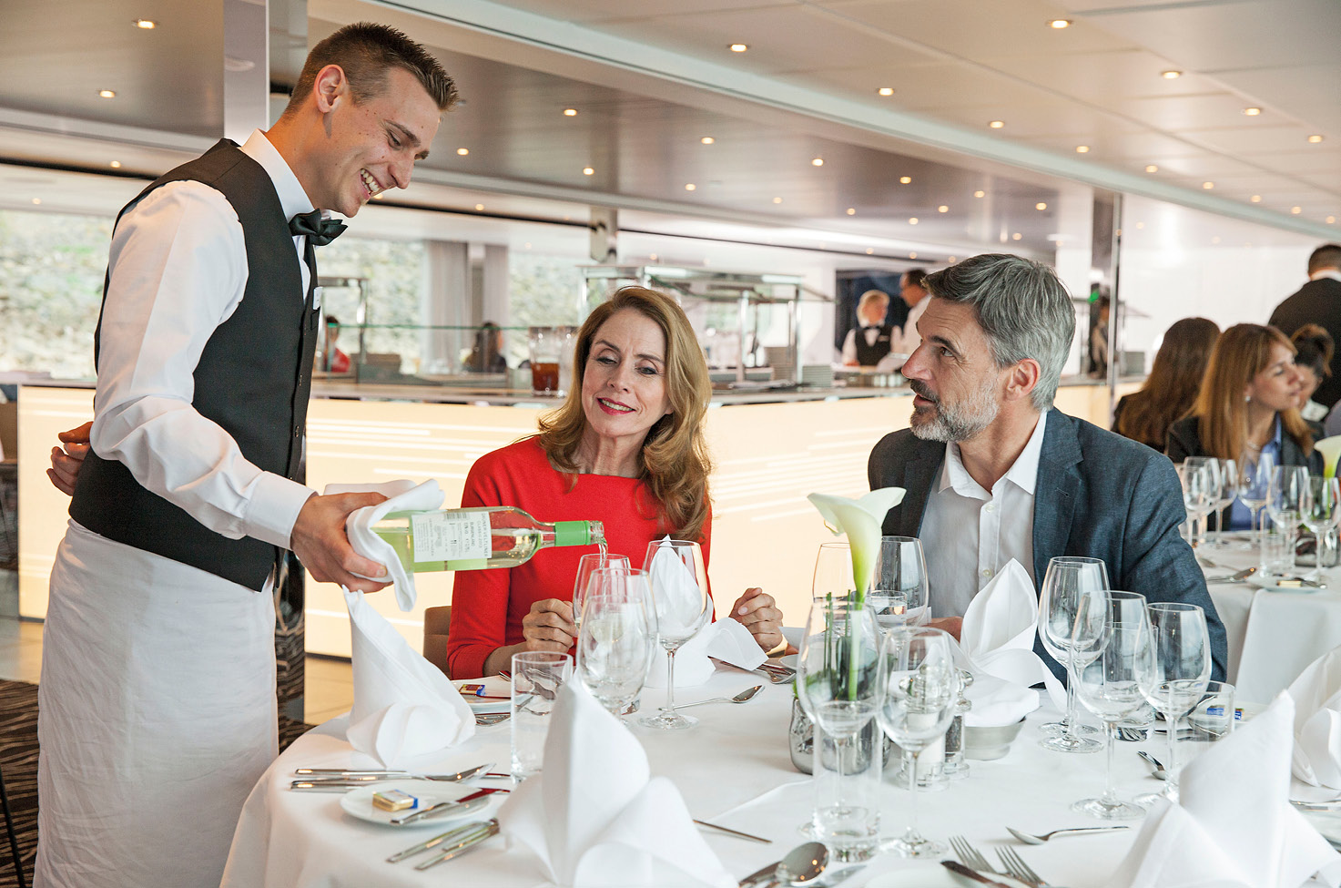 Couple enjoying wine and a meal on board a luxury river ship 
