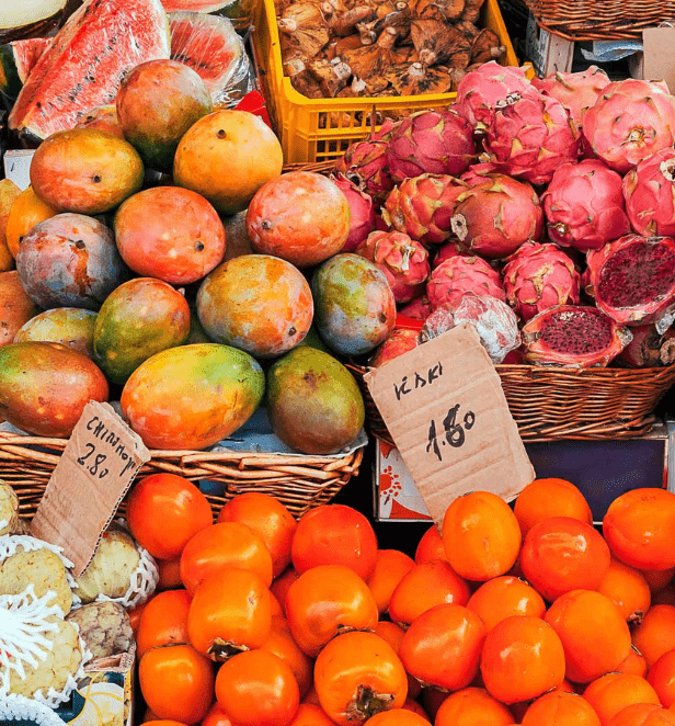 Vibrant colored fruits on a table at a market stall
