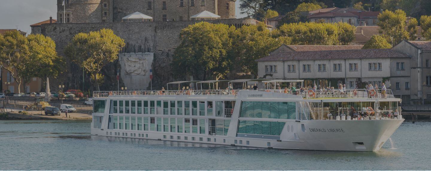 Emerald Liberté river cruise ship sailing past historic buildings