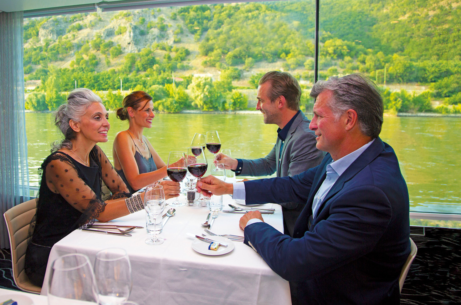 Four cruise guests enjoying a drink before their evening meal