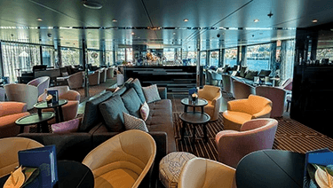 Modern and stylish bar and lounge area on board a luxury river ship sailing the Mekong in Southeast Asia
