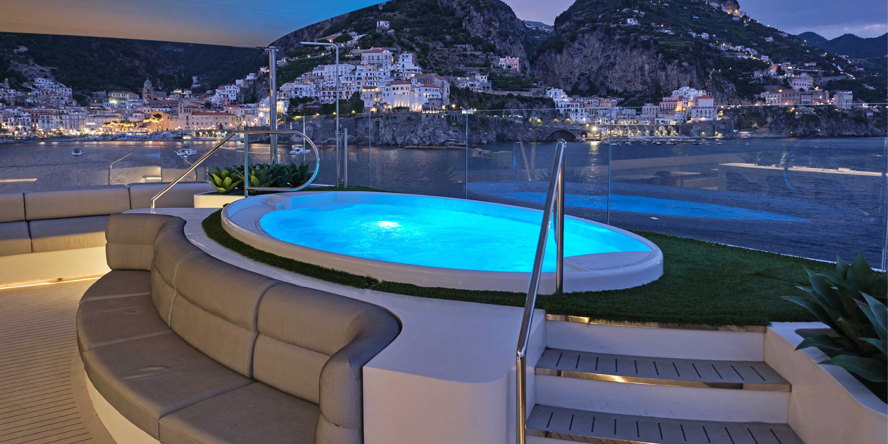 A large hot tub with panoramic views across the stunning landscape of the Mediterranean, next to a top deck bar