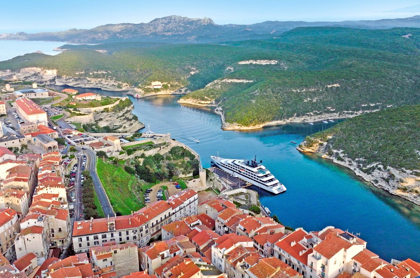 An aerial shot of an Emerald Cruises yacht docked in the heart of Bonifacio, Corsica, France
