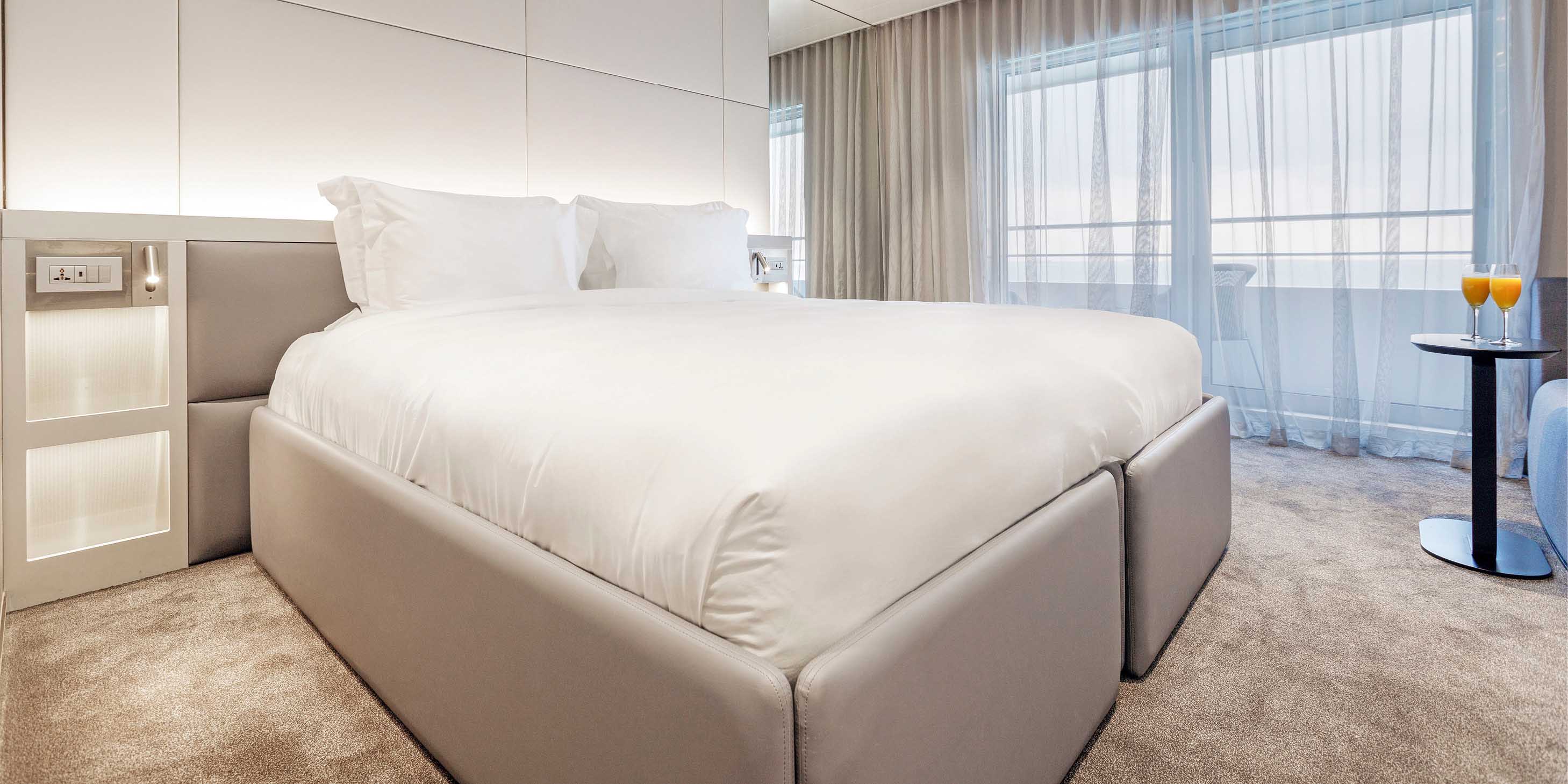 A spacious balcony suite cabin with private balcony on an Emerald Cruises yacht